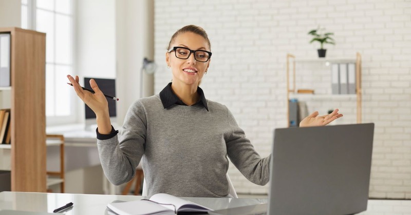 woman shocked at something while looking at her laptop