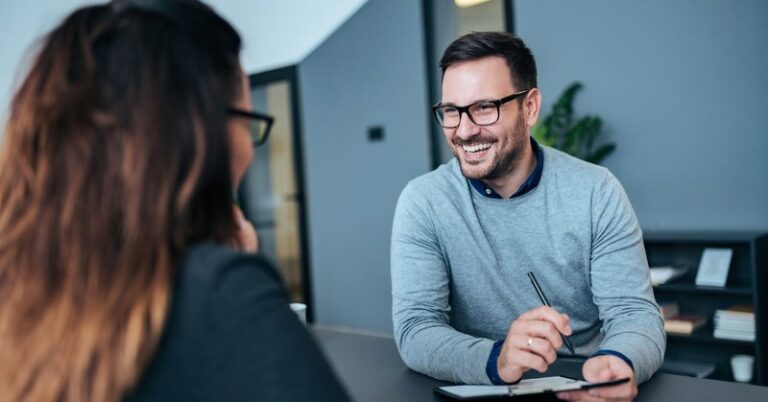 a person being interviewed by a male hiring manager