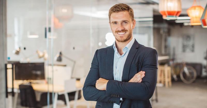 an office worker with arms crossed and positive body language