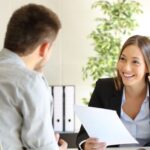 female interviewer giving an okay sign to a male interviewee